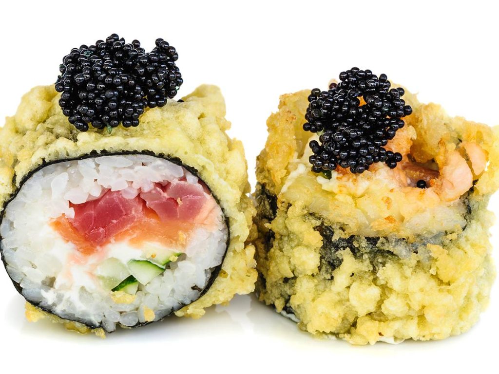 Tempura hot fried sushi maki with tuna, salmon, avocado, cucumber and cream cheese, topped with black tobiko